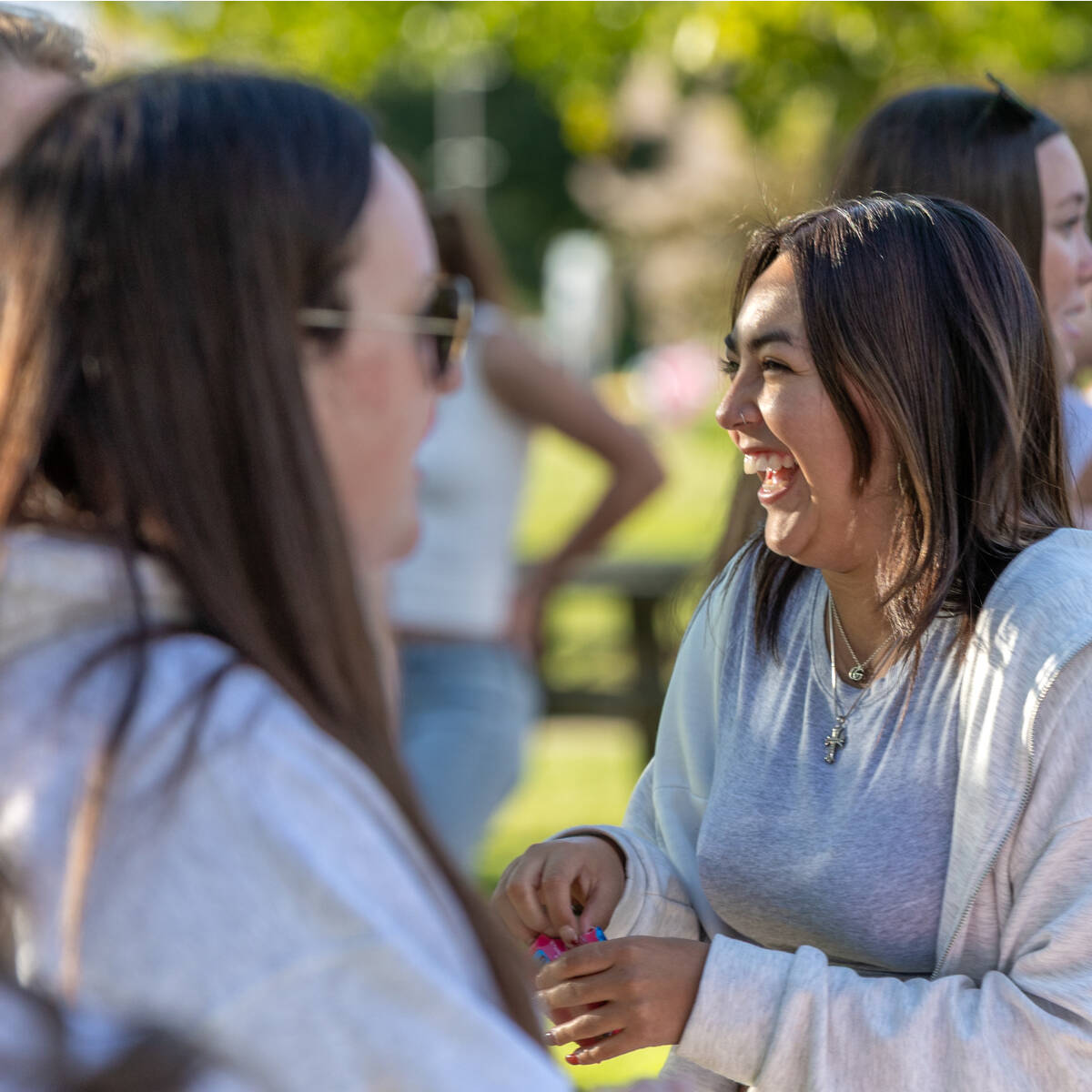 Two students chatting and laughing on the Kirkhof Lawn